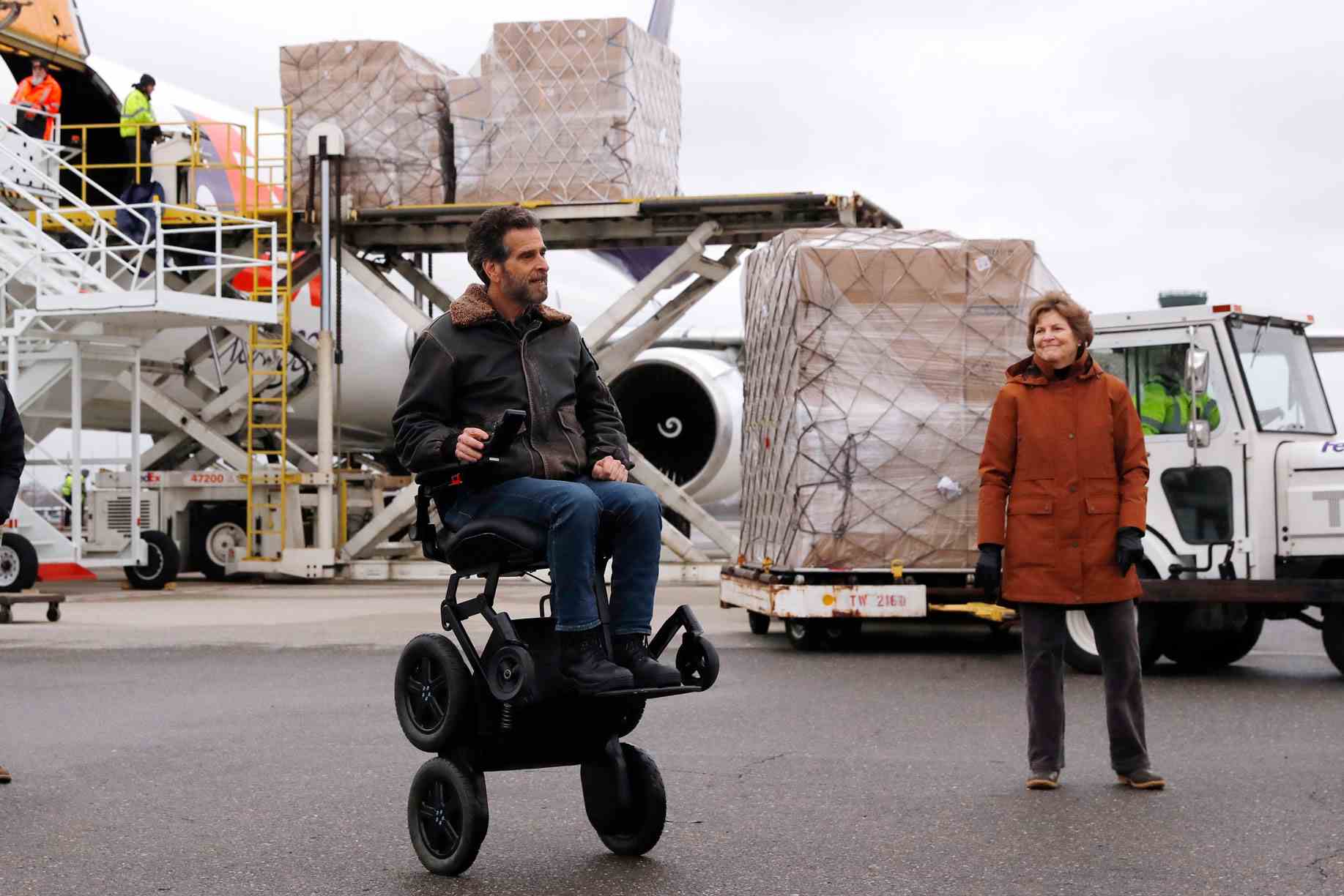 US-Senatorin Jeanne Shaheen (D-NH), rechts, blickt auf den Erfinder Dean Kamen, als über 110.000 Pfund persönliche Schutzausrüstung (PSA) aus Shanghai, China, geliefert wurden, um medizinisches Personal und Ersthelfer im Kampf gegen den Ausbruch des COVID-19-Virus zu schützen. wird aus einem Frachtflugzeug am Regionalflughafen Manchester-Boston in Manchester, New Hampshire, am Donnerstag, den 30