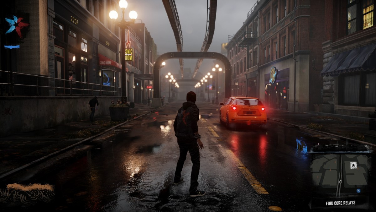 Ein Bild aus Infamous: Second Sun, in dem Delsin in den Straßen von Seattle steht.  Das Bild ist Teil eines Artikels über die besten Spiele wie Marvel's Spider-Man 2.