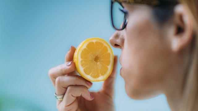 woman smelling lemon