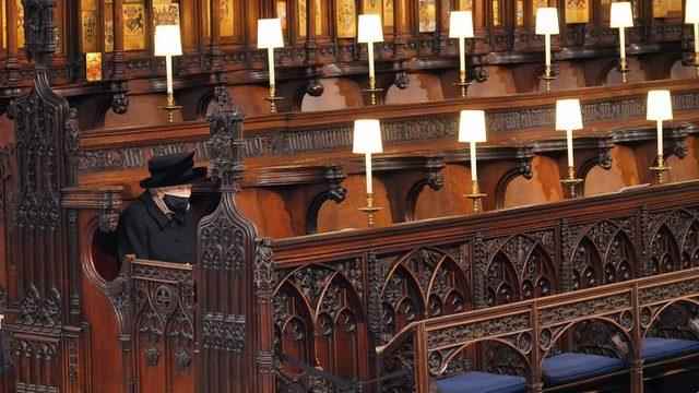 Karilce sits alone at the funeral