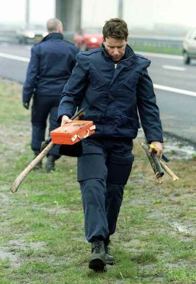 A policeman collects some of the weapons used.