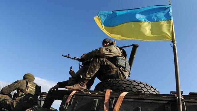 Tank driver waving the Ukrainian flag