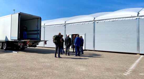 Unpacking washing machines and carrying coat racks emergency shelter Zeist