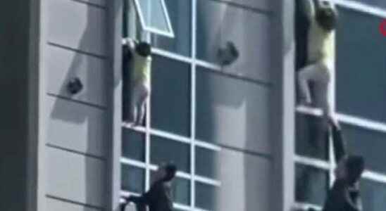 Scary moments 3 year old boy hangs in 8th floor window