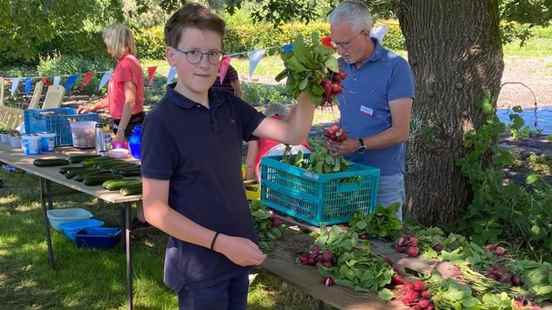 Families collect first harvest at their own organic farm in