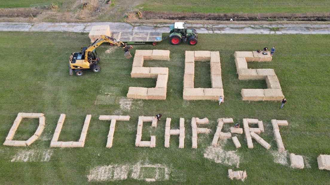 Writing with straw bales.