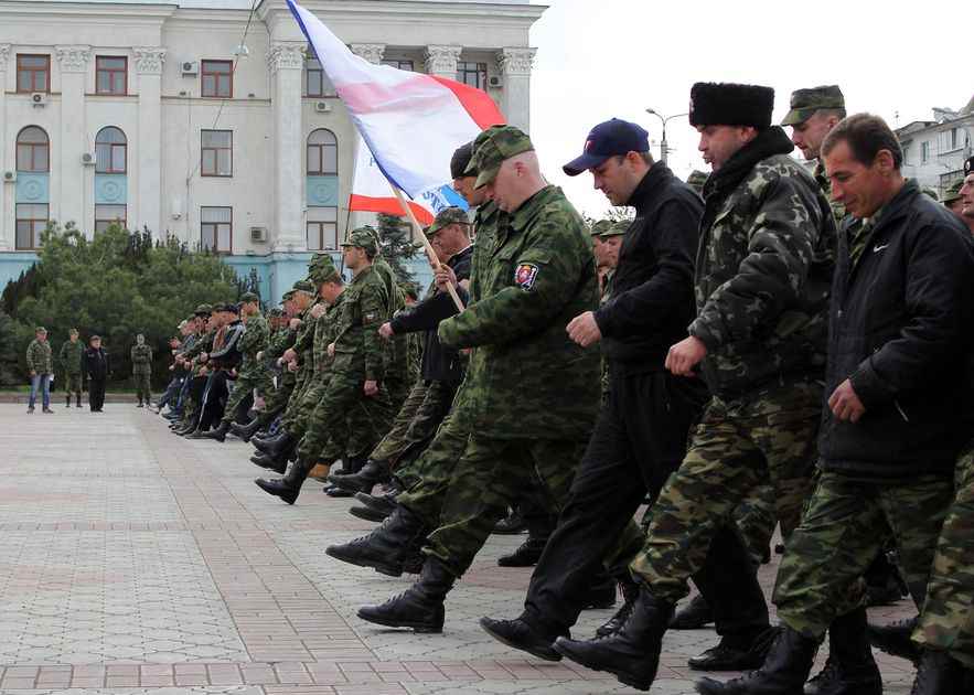 Russian soldiers and pro-Russian volunteers rehearse before a parade on April 12, 2014 in Simferopol, Crimea.