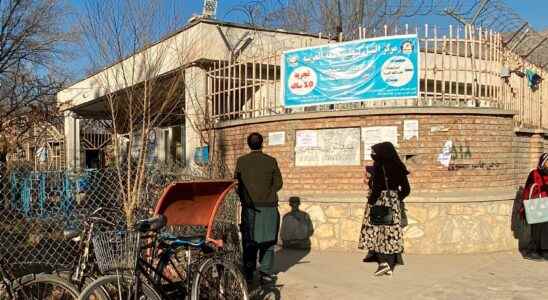 Women are stopped by guards at a university in Kabul