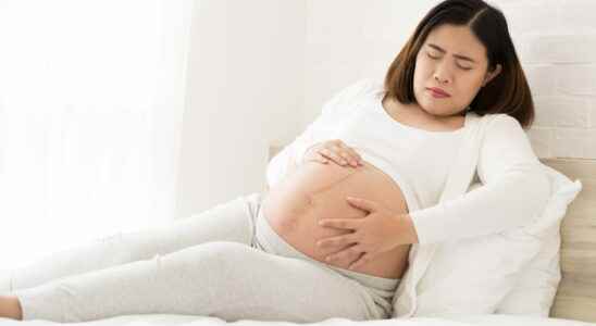 Hard belly pregnancy in which month what causes