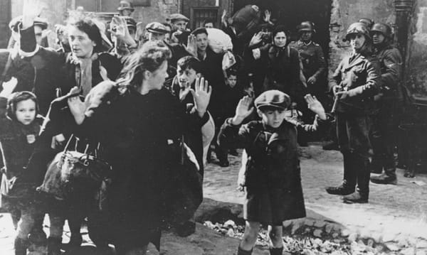 A group of Jews are escorted out of the ghetto