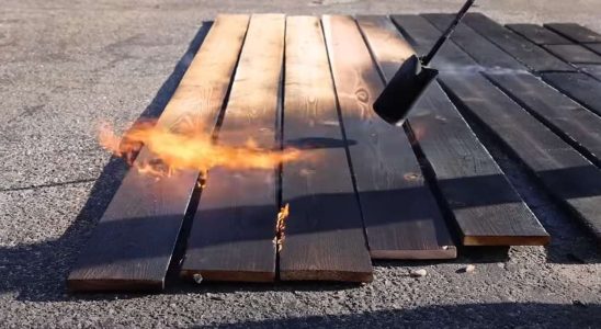 It burns the surface of flower bed boards after