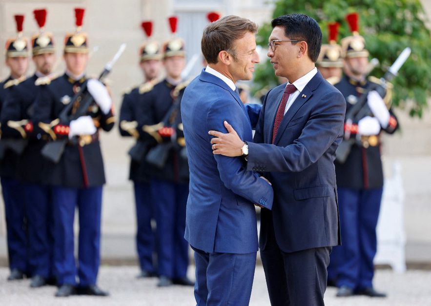 French President Emmanuel Macron greets Malagasy President Andry Rajoelina at the Elysée presidential palace on August 29, 2022