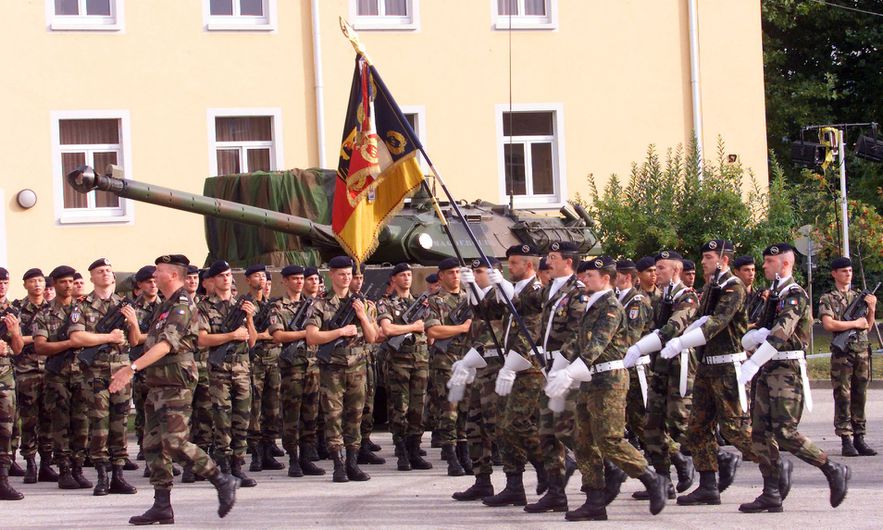 Soldiers carrying the regiment's flag parade in front of the troops during ceremonies marking the 10th anniversary of the Franco-German brigade, September 24, 1999 in Mullheim