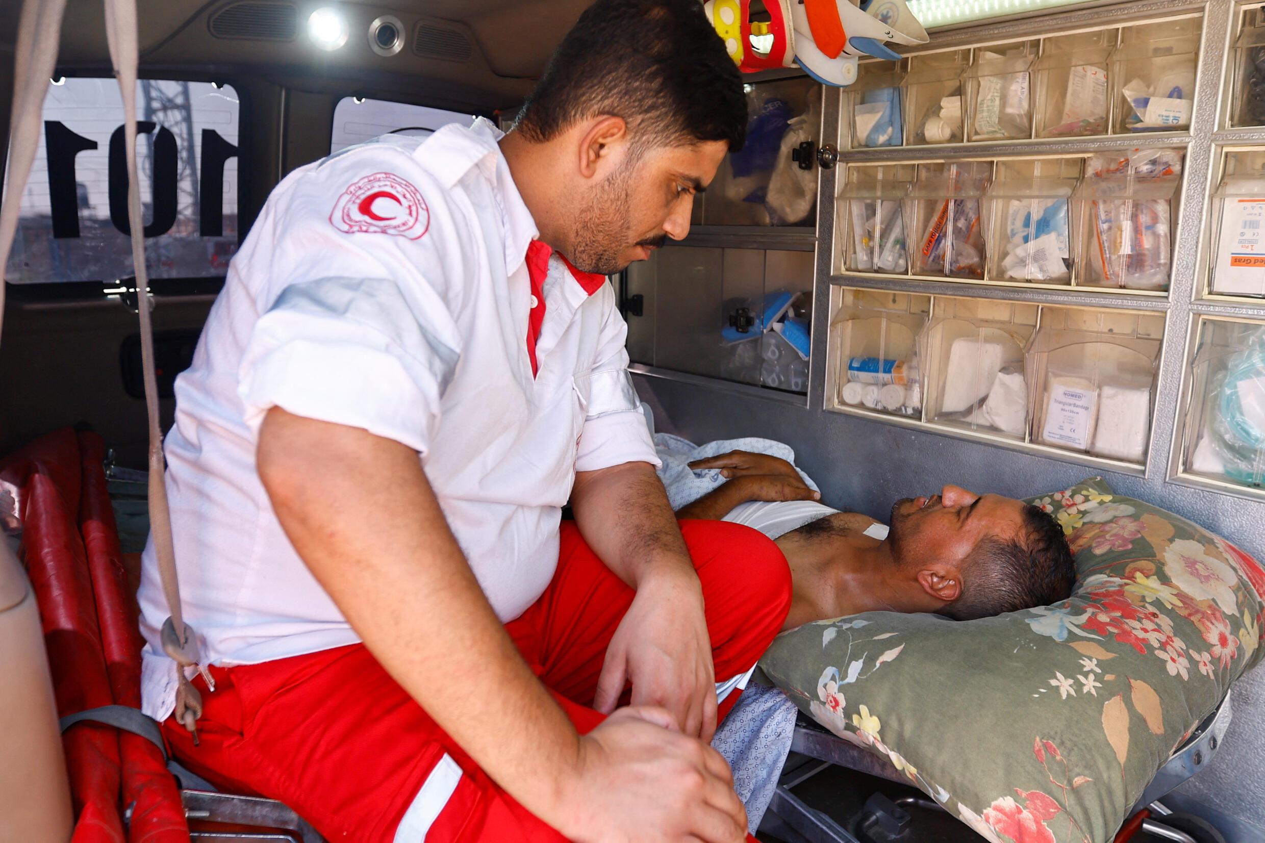 A doctor attends to an injured Palestinian, who will be transferred to an Egyptian hospital after crossing the border with Rafah, in the south of the Gaza Strip, November 1, 2023.