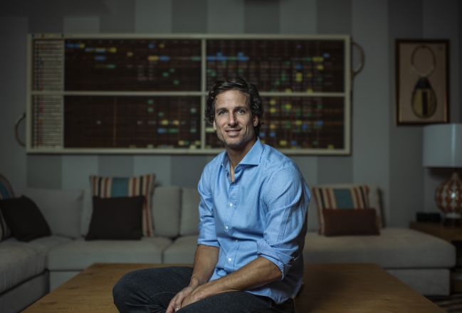 Feliciano López, in front of a handmade mural, in which are the main results of his races.