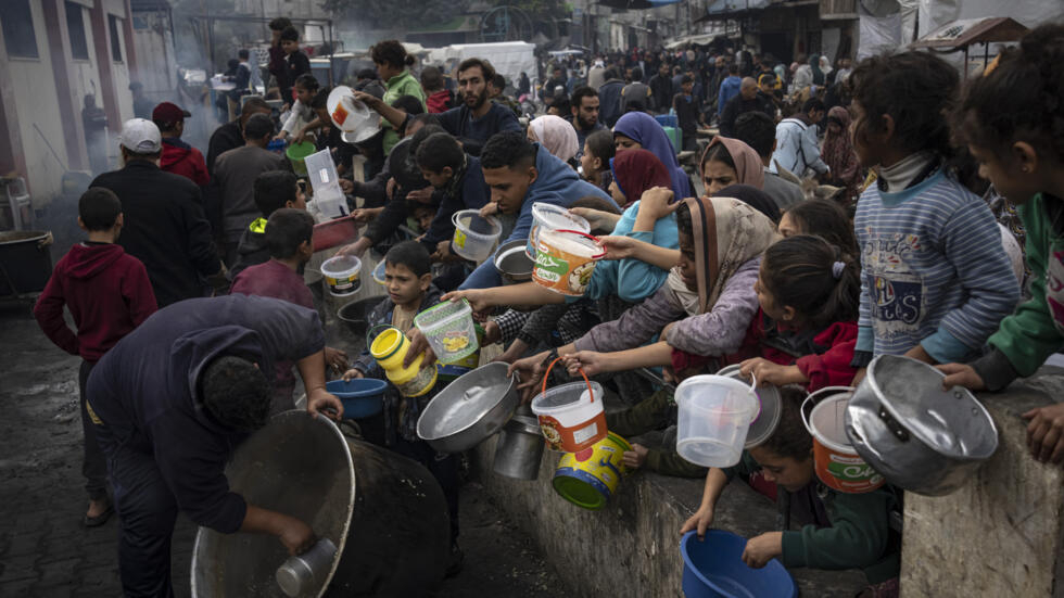 Palestinians queue for a free meal in Rafah, Gaza Strip, Thursday, December 21, 2023.