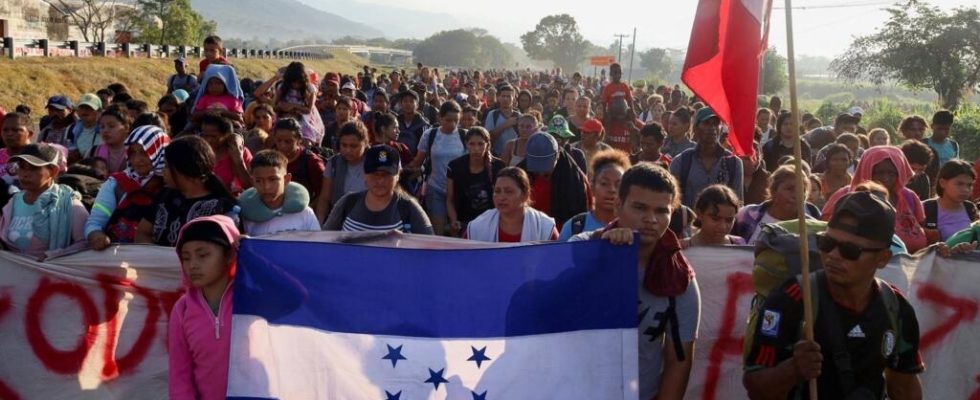 Thousands of migrants march toward the United States in an