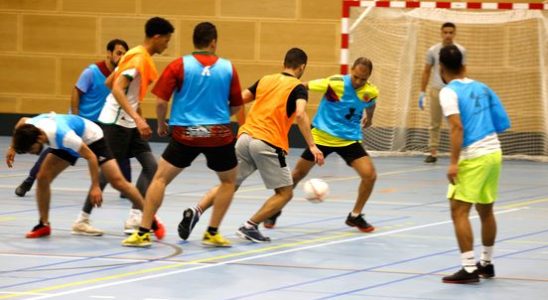 Refugees play football against each other in Utrecht sports hall