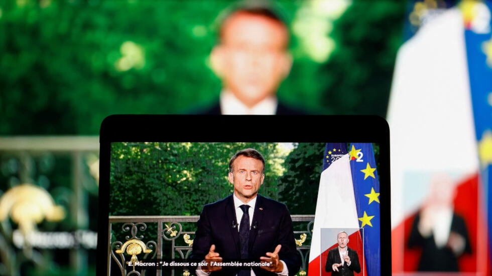 French President Emmanuel Macron appears on a screen as he delivers a speech following the results after the close of voting in the European Parliament elections, in Paris, France, June 9, 2024.