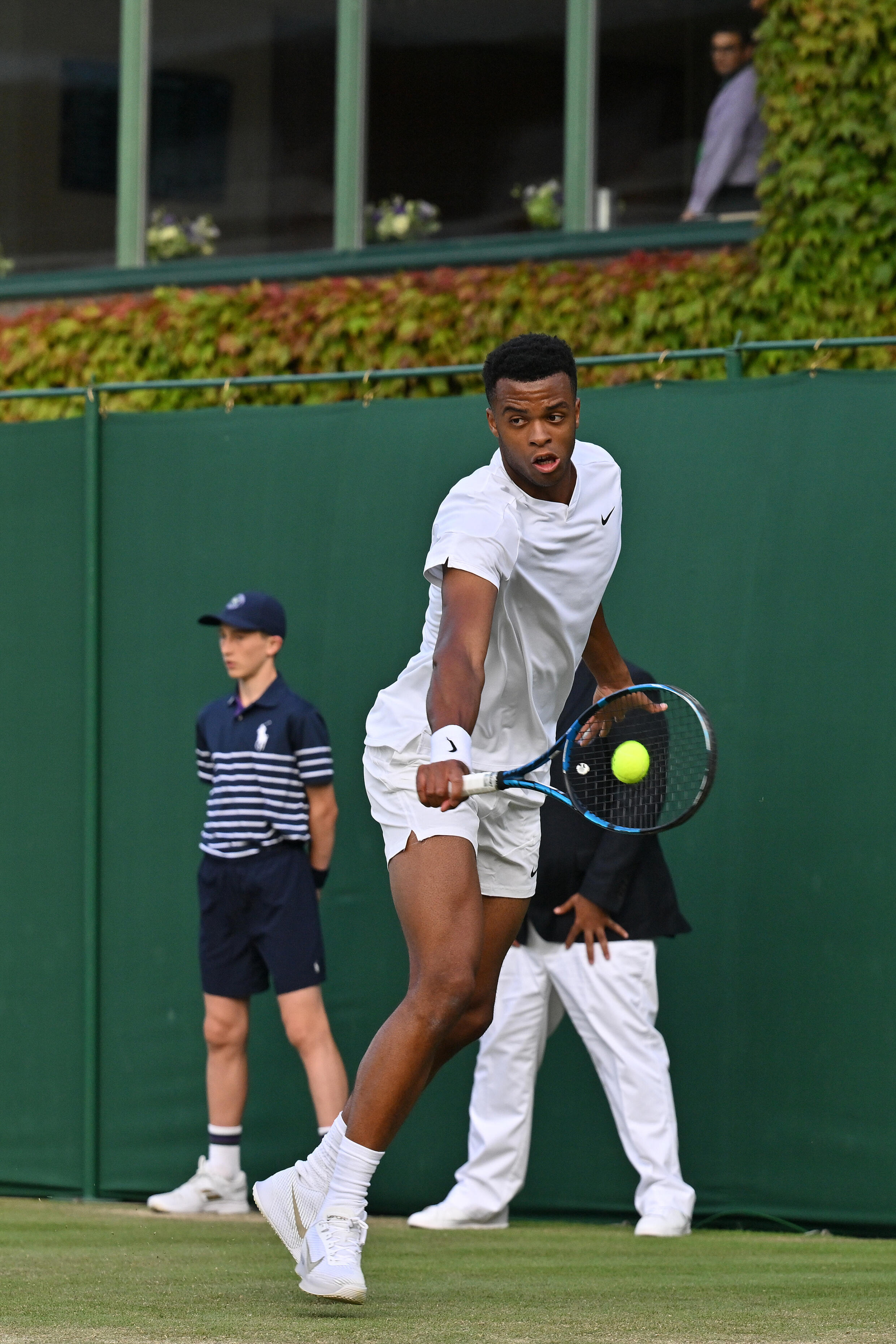 Frenchman Giovanni Mpetshi Perricard returns to Japan's Yoshihito Nishioka in the second round of the Wimbledon tournament on July 4, 2024, in London.