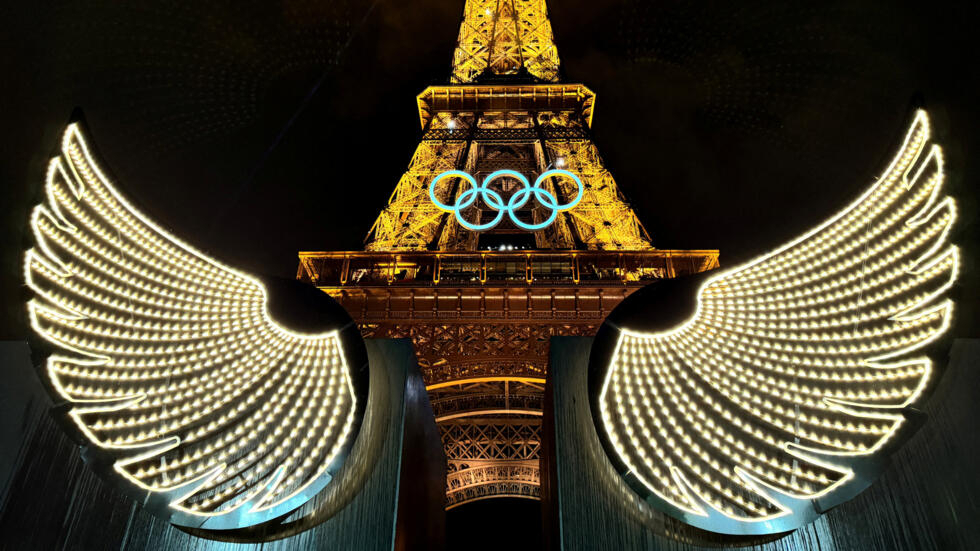 The Eiffel Tower lights up for the opening ceremony of the Olympic Games.