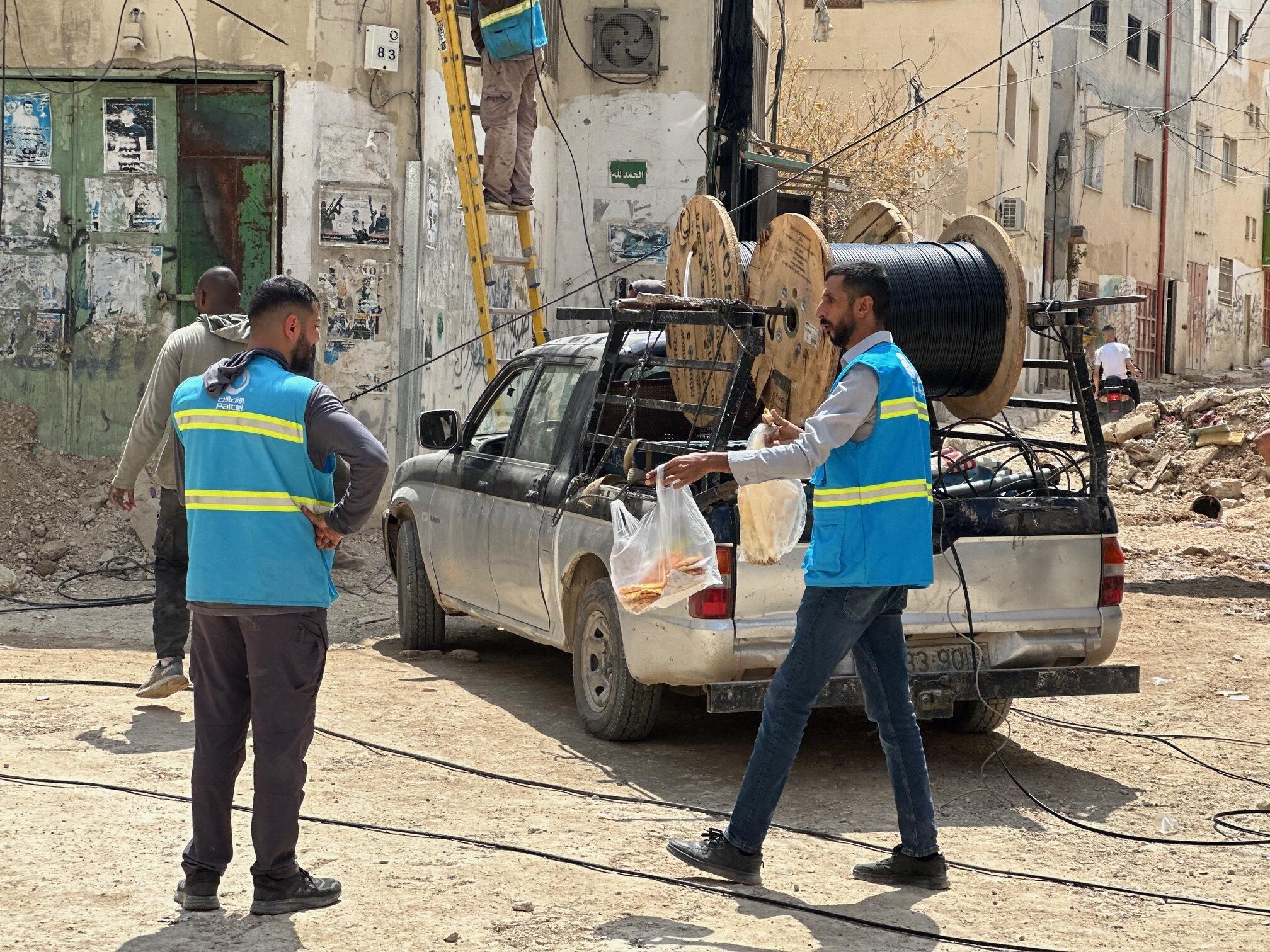 Palestinian telecommunications company employees restore telephone lines. Water, sewage and electricity networks were also damaged during the Israeli offensive.