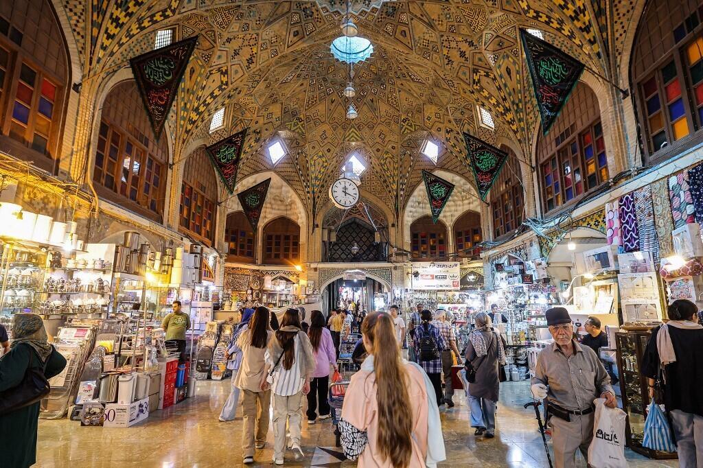 Women without veils walk through the Grand Bazaar in Tehran on September 5, 2023.