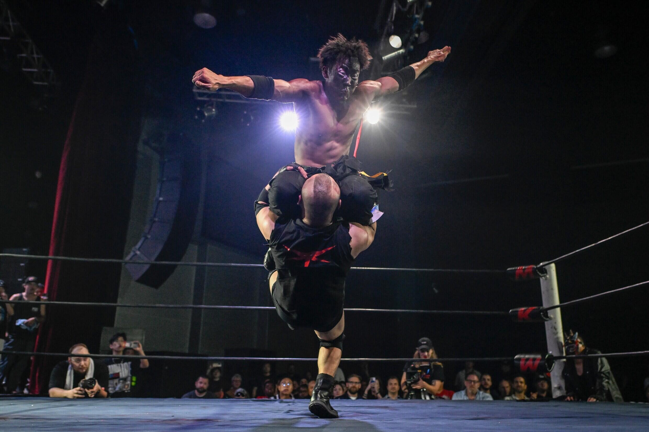 Wrestler Chen Wenbion jumps on his opponent during a Middle Kingdom Wrestling (MKW) championship on September 14, 2024 in Shanghai.